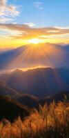 breathtaking sunrise over mountains, casting golden rays and illuminating landscape. scene evokes tranquility and natural beauty photo