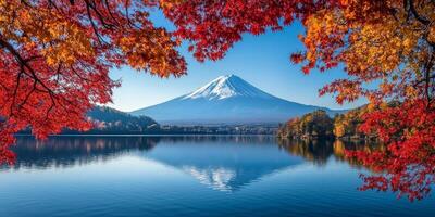 Mount Fuji reflected in serene lake, surrounded by vibrant autumn foliage. scene captures beauty of nature in tranquil photo
