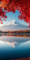 Majestic Mount Fuji reflected in serene lake, surrounded by vibrant autumn foliage. clear blue sky enhances stunning landscape, creating peaceful photo