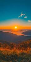 breathtaking sunset over rolling mountains, casting warm hues across landscape. serene atmosphere invites tranquility and reflection, showcasing nature beauty photo