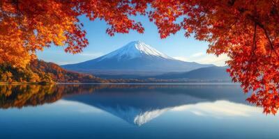 Mount Fuji reflected in serene lake, surrounded by vibrant autumn foliage. scene captures beauty of nature in tranquil setting photo