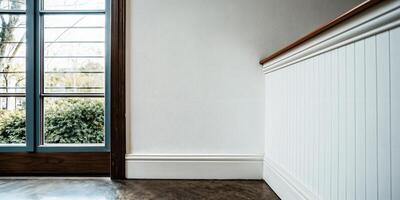 Minimalist Empty Room with Wainscoting and Large Window photo