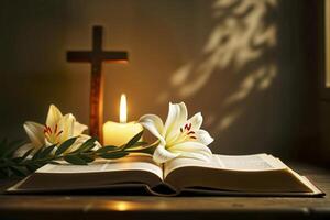 Open Bible with Easter lily, candle, and cross in warm light. photo