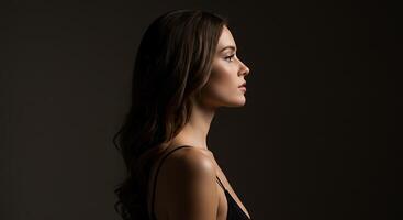 Elegant woman in profile with soft, subtle lighting, conveying inner reflection - Generated using AI photo