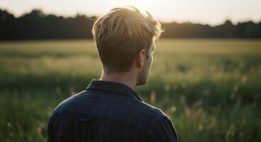 Contemplative figure in a field at sunset - Generated using AI photo