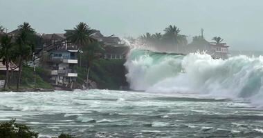 A huge tsunami wave hit a coastal residential complex, destroying everything in its path. video