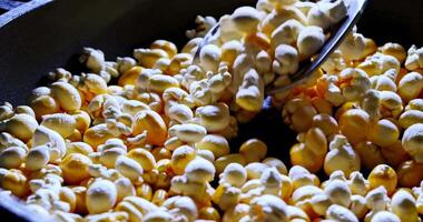 popcorn being fried in a pan with dramatic lighting video