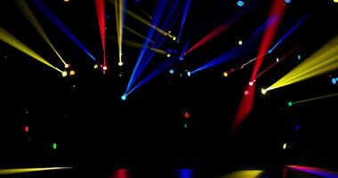 multitude of multi-colored stage lights with narrow colored beams of light on a dark stage background video