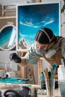 Attentive thorough woman working carefully with epoxy resin, creating making artwork painting. photo