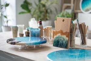 Artist workbench creating paintings artworks from epoxy resin. Table equipped for creative work. photo