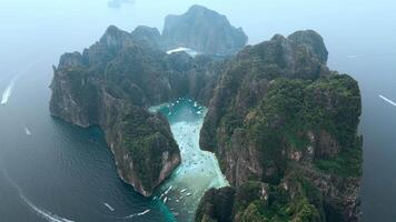 Top view of the whole island of Ko Phi Phi Lee with iconic Maya Bay and Pileh Lagoon surrounded by limestone cliffs on Phi Phi islands in Thailand. Thailand's most popular tourist attraction. video