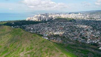 Waikiki Honolulu Hawaii - stunning aerial view of the city skyline, lush green hills, and the Pacific Ocean, showcasing the perfect blend of urban and natural beauty video