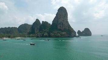 Railay beach, aerial view. Beautiful limestone cliffs of idyllic Thailand Ao Nang beach. Paradise Krabi resort with scenic rock formation. Many boats for transporting tourists float on the beach video