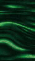 An emerald flow of smooth, flowing silk. The gentle curves and play of light give it an elegant and calm aesthetic, evoking a sense of fluidity and depth. video