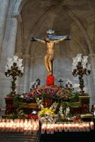 Holy week traditions in Spain. Religious procession with crucifix and flowers photo