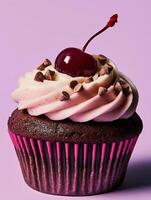 A cupcake with chocolate frosting and a cherry on top photo