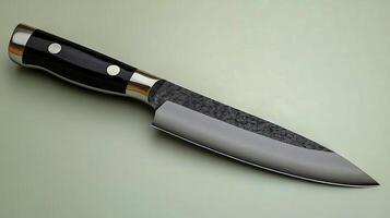 A sharp, classic stainless steel knife with a sleek black handle rests against a gray background photo
