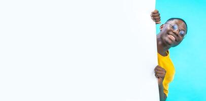 Banner with a black boy coming out from behind a white big board with copy space for text and design photo