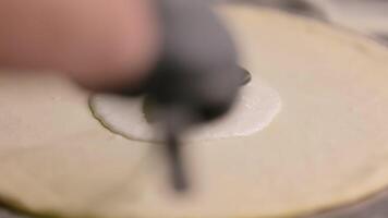 Chef working in pizzeria. Hands of chef making pizza on floured black table video