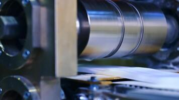The big drum rotates in close-up.. The outer layer of diapers is made on the machine. video