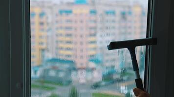 Cleaning window with squeegee. Window cleaner with squeegee cleaning glass window video