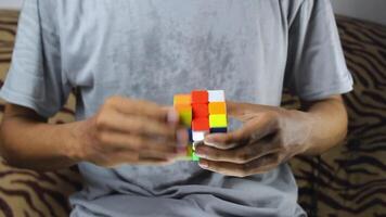 close up of man's hand playing rubik's cube. man trying to solve rubik's cube quickly. video