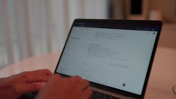 Chatting with a modern technology chat bot. Close-up of hands typing on a laptop, with focus on an open email inbox on the screen. This environment is reminiscent of a home office or a quiet workspace video