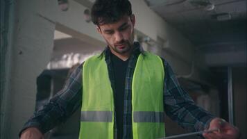 Caucasian builder constructor professional technician man using roulette measuring tape male engineer guy building plan worker tool construction measures repair architect foreman inspector equipment video