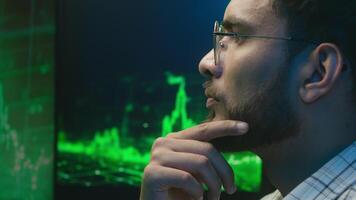 Arabian Indian man programmer businessman currency crypto thoughtful doubtful office computer hacker broker thinking trader male trading analysis solution ponder investment unsure guy business night video