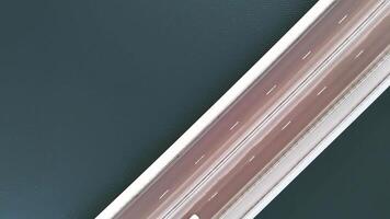 Top-down view of modern bridge over calm water with clean, minimalist design video