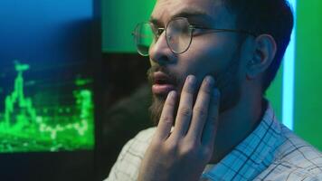 Close up face nervous Arabian Indian man looking computer monitor data problem trouble male guy businessman error loss business indoor stressed programmer trader freelancer anxious upset coder failure video