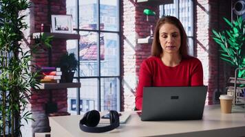 Mature woman dialing a phone number to make inquiries about productivity, solving tasks remotely from the comfort of her home. Female freelancer on a phone call, briefing. Camera B. video