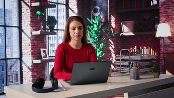 Confident woman solving her tasks on a freelance platform at home, answering emails and multitasking. Mature worker staying connected and enjoying the flexibility of working remotely. Camera B. video