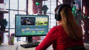 Female filmmaker working on media post production from agency office, ensuring the editing timeline and color correction for shoot. Tech driven workspace showcases workflow. Camera B. video