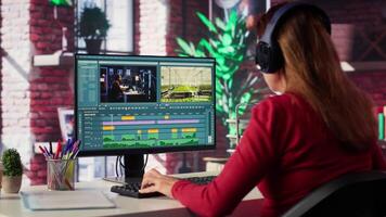 Focused editor woman works on montage in a creative software at home, digital media. Filmmaker using dual monitors to edit footage and create content, post production. Camera A. video