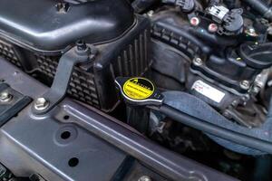 A car radiator cap with warning sticker Never open when hot photo