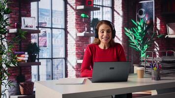 Joyful woman hosting a virtual family meeting online via conference, meeting with the relatives and sharing latest news. Person uses web connection to keep in touch with loved ones. Camera B. video