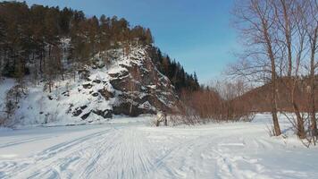A snowy road with trees and rocks in the background video