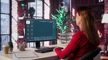 Woman expert developer works with photo editing software in her loft, digital media. Using dual monitors to ensure productivity and innovation in the graphic design world. Camera B. video