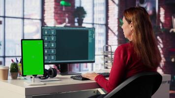 Mature adult utilizes a digital AI tool on web interface next to green screen, remote work. Artificial intelligence powered interface simplifies communication and increases efficiency. Camera A. video