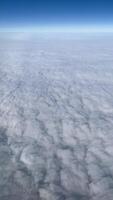 vertical View of the blue Sky above the clouds from the airplane window video
