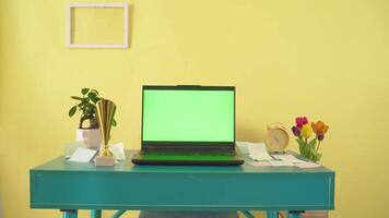 Laptop Green Screen Display Open on Yellow Background Mock-up. Empty Green Monitor for Call, Website Template News or Game Applications. One Blank Technology Zoom video
