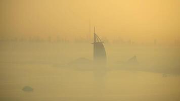 A boat slowly floats on water surrounded by fog on a misty day video
