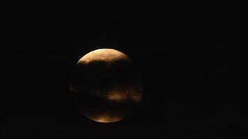 Full moon rises through clouds illuminating the dark sky in a breathtaking cinematic time lapse experience video