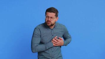Stressed ill sick man suffers from tension holding chest with heart pain attack risk of stroke video