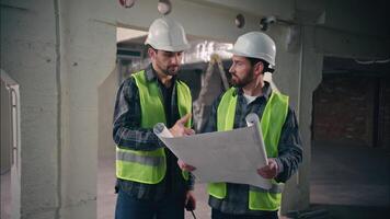 Caucasian men contractors builders males workers engineers discuss talking information in blueprint managers planning guys shaking hands agreement teamwork building project collaboration construction video