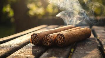 Three cigars on a wooden table with smoke coming out photo