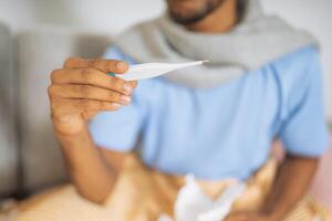 Man looking at the digital thermometer photo