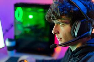Man with gaming headset playing computer game photo