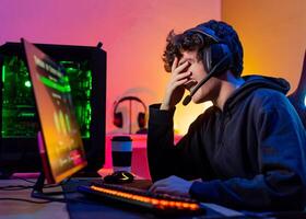 Laughing man playing game on computer photo